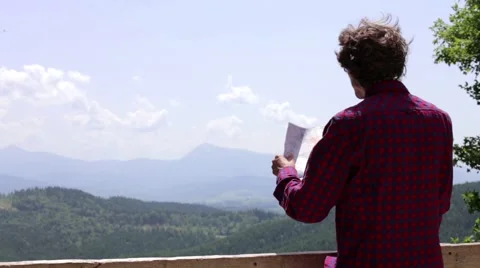 In the mountains a man looking a map and compass Stock Footage 64997508