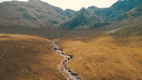 Mountains overlooking a river with fast moving clouds - Drone 4K 動画素材 113745949