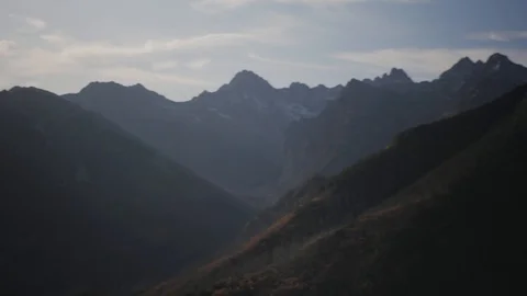 Mountains pan shot during sunrise Stock Footage