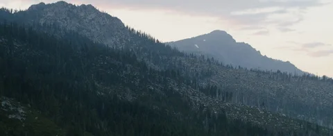 Mountains ranges covered with trees during sunset Stock Footage 92051894