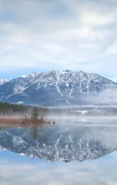 Mountains reflected in alpine lake Stock Photos