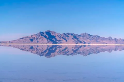 Mountains reflected as mirror image in still water Stock Photos