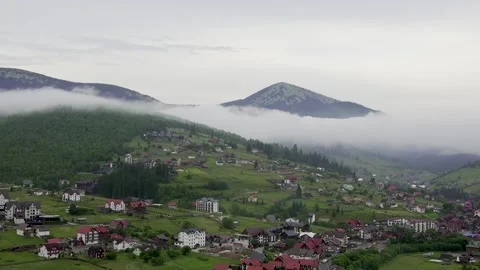Mountains rise above the clouds of thick fog. Footage from a bird's eye view Stock Footage 304705146