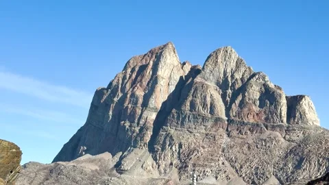 Mountains rise under clear blue sky in a remote location during daytime Stock Footage 339999071