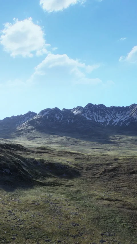 Mountains rise under a clear sky with a vast landscape stretching below Stock Footage 339107859