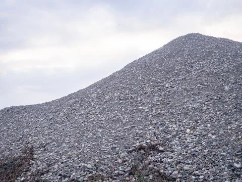 Mountains of rubble. Gray background. Construction material. Crushed stone .. Stock Photos