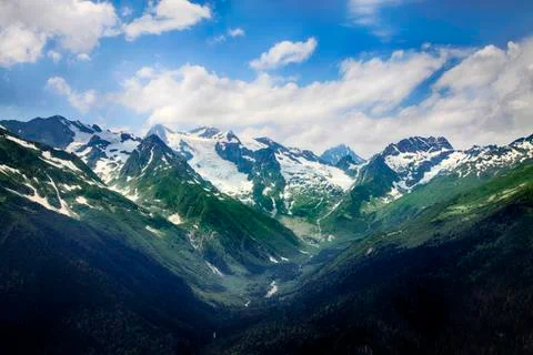 Mountains scene with dramatic blue sky in national park of Dombay Stock Photos
