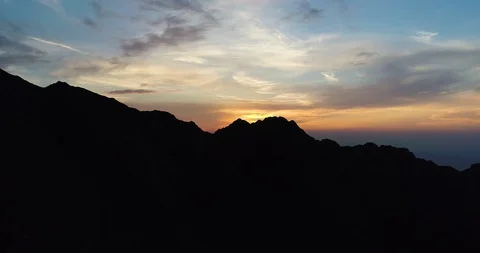 Mountains shaped by the light of the golden sunset. Video stock 128752154