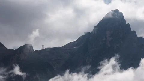 The mountains shrouded in clouds seen from San Martino di Castrozza - Italy Stock Footage 315514519