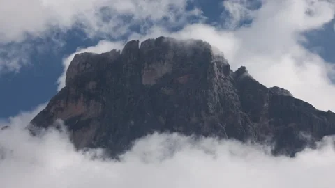 The mountains shrouded in clouds seen from San Martino di Castrozza - Italy Stock Footage 315514522