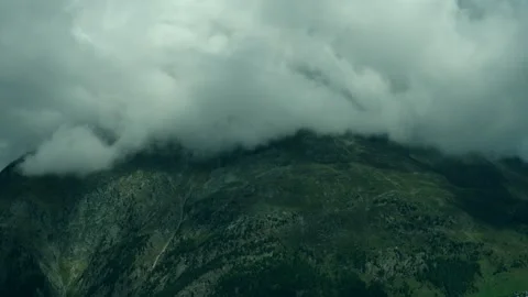 Mountains Shrouded in Dense Clouds over a Vast Alpine Landscape in Summer 库存影片 331164173