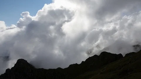 Mountains silhouette on a background of boiling clouds. Highland scenery. Stock-Footage 83730632