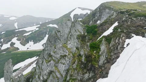 Mountains spring snow stone rock clouds sky background Stock Footage 277106457