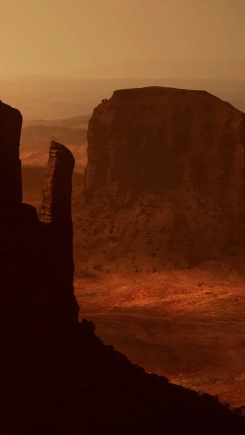 Mountains stand tall in desert during sunset in Monument Valley region Stock Footage 340880848