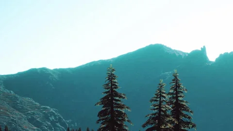 Mountains stand tall with trees below and bright sky above in clear day Stock Footage 340232754
