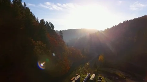 Mountains at sunset, forest valley panoramic view over railway station Vídeo Stock 124077665