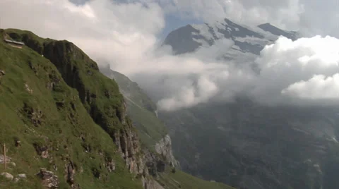 Mountains surrounded by clouds - Swiss Alps Stock Footage 32190890