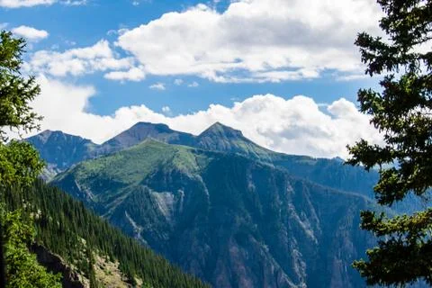 Mountains through trees Stock Photos