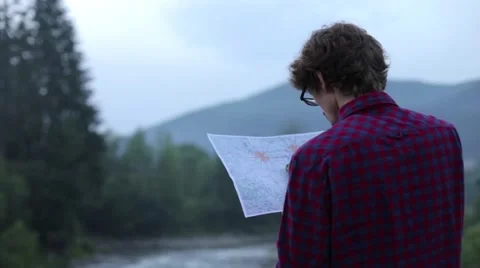 In the mountains, Tourist looking at a map Stock Footage 64684240