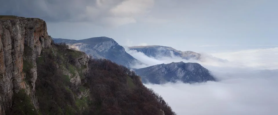 Mountains tower over the clouds Stock Photos