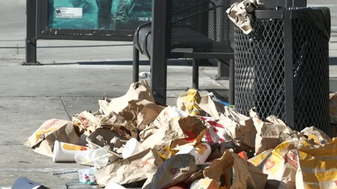 Mountains of trash at a bus stop shelter Stock Video Pond5