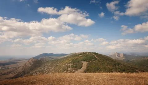 Mountains under the blue sky with clouds Stock Photos