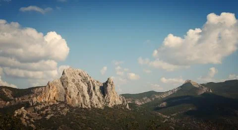 Mountains under the blue sky with clouds Stock Photos