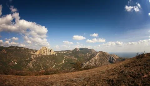 Mountains under the blue sky with clouds Stock Photos