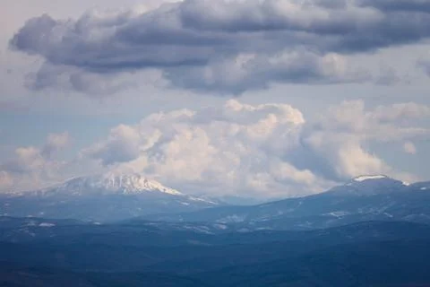 Mountains under the cloudy sky Stock Photos