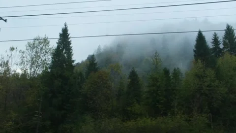 Mountains view through train window. Passenger train compartment passing by Stock Footage 264027695