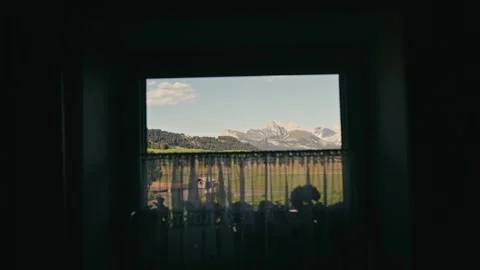Mountains Visible Through a Window Frame with Soft Light and Green Fields 库存影片 331166079