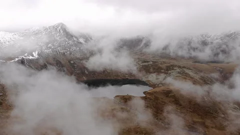 Mountains in white clouds. A mountain lake is seen through a thick veil of fog Stock Footage 167050140