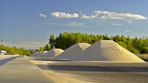 Mountains of white sand lie on side of road Stock Footage 77187239