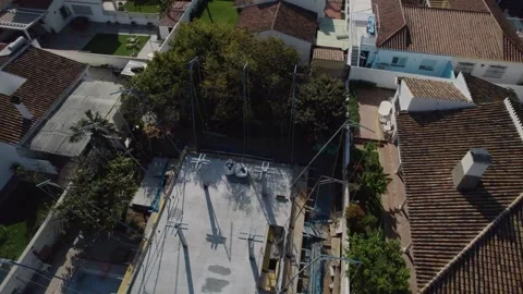 From the mountainside, rooftops of buildings create a patchwork against Stock Footage 244200805