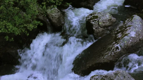 MountainsideWaterSurge-BreachingOverRocks Stock Footage 38725823