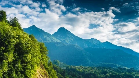 Mountaints and trees at cloudy sunset time lapse Stock Footage 82188030