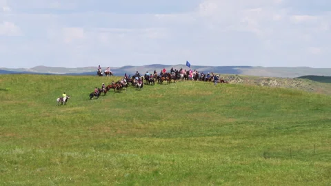 Mounted riders begin to charge in summer grass Stock Footage 271157313