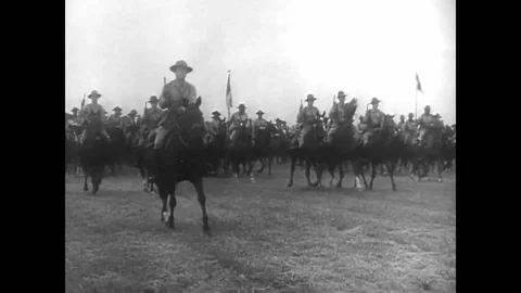 Mounted troops in the United States Cavalry horseback ride on a trail and make a Stock-Footage 99349148
