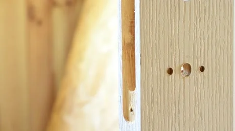Mounting a door lock. Inserting mortise lock into pocket Stock Footage 50493605