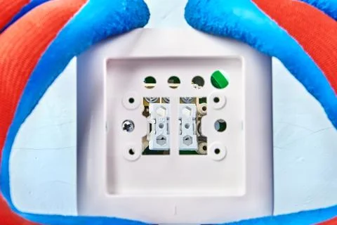 Mounting of light switch by worker. Stock Photos