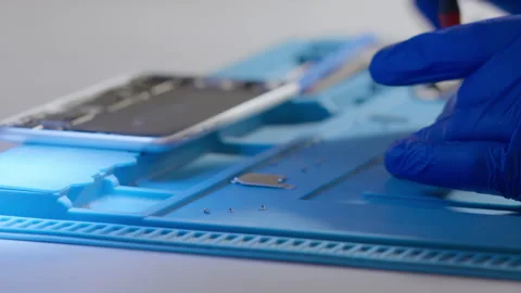 Mounting or assembling a mobile device. Loosen micro screws in the workshop. Stock Footage 166919798