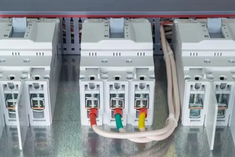 On the mounting panel there are three power circuit breaker. Stock Photos