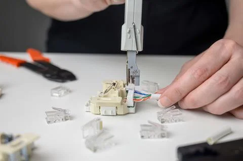 Mounting the RJ45 module, attaching the wire to the computer socket in the .. Stock Photos