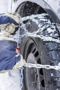 Mounting snow chains Stock Photos