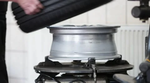 Mounting tire on the rim Stock Footage 54234288