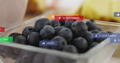 Mouse clicking badges popping and drifting over square jar of blueberries Stock Footage 323384853