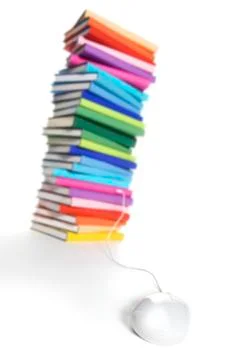 Mouse connected to multi-colored book stack Stock Photos