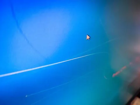 A mouse cursor arrow on a blue computer screen. Foto stock