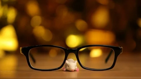 Mouse glasses wooden table background Stock Footage 117589052