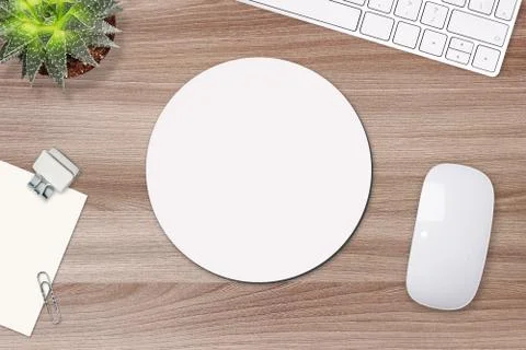 Mouse pad mockup. Round white mat on the table with props, mouse and keyboard Stock Photos